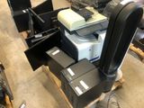 a pile of computer equipment sitting on a pallet in a warehouse