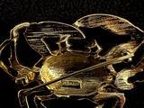a gold crab brooch on a black surface