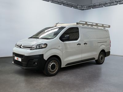 the white van is parked in a large room with white walls