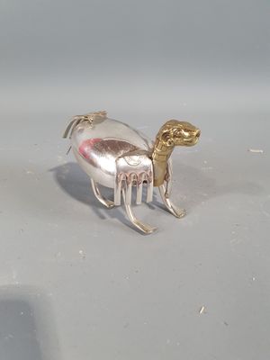 a silver object with a horse on it on a table