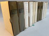 several books are lined up in a row on a table