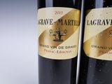 two bottles of wine sitting next to each other on a table