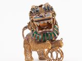gold and enamel figurine of an elephant pulling a cart