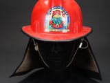 fireman ' s helmet on a mannequin head on a black background