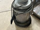 a machine that is sitting on the floor next to a pair of shoes