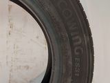 a close up of a tire on a white surface with a wall in the background