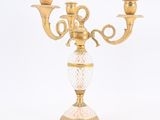 a gold colored candelab with two candles on it