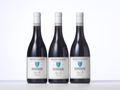 three bottles of wine sitting on top of a table next to each other