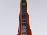 a close up of a guitar hanging from a string