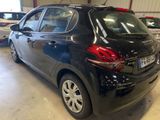 a black car parked in a garage with other cars in the background