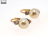 pair of pearl and diamond earrings on a white background