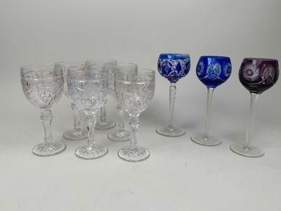 several wine glasses are lined up in a row on a white surface