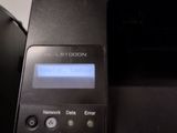 a black printer with a blue screen on top of it