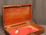 a wooden box with a red cloth inside of it