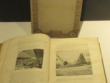 un livre ouvert posé sur une table à côté d'une boîte