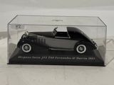 a black and silver model of a car in a display case