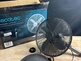 an electric fan sitting on top of a wooden table next to a box