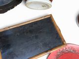 a blackboard and a red plate on a white table