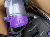 a purple vacuum that is sitting in a box