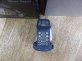 a blue cell phone sitting on a table next to a box