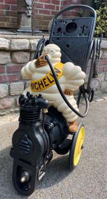 une statue représentant un homme à moto avec une pompe à essence
