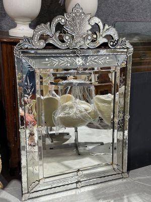 a mirror that is sitting on a table next to a vase