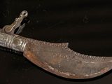 a very old knife that is on display in a museum