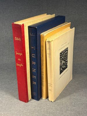 three books are stacked on top of each other on a gray surface