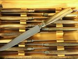 many knives in a wooden case on the table