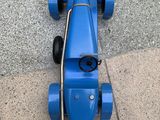 a blue toy car that is sitting on the ground