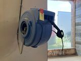 a blue blower sitting on the wall in a room