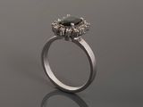a close up of a ring with a black stone surrounded by white diamonds