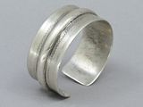 a close up of a silver ring on a gray surface