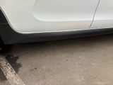 a white car that is parked in a parking lot