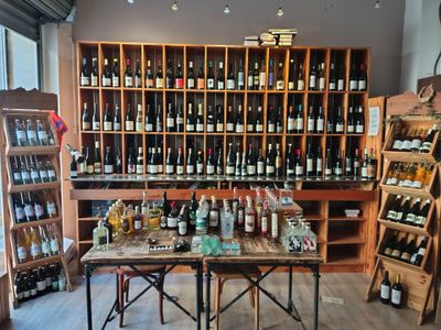 many bottles of wine on the shelves in the store