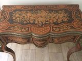 a small table with a floral design on it