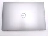 dell laptop computer sitting on a white surface with a dell logo on the screen