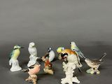 many figurines of birds that are sitting on top of each other