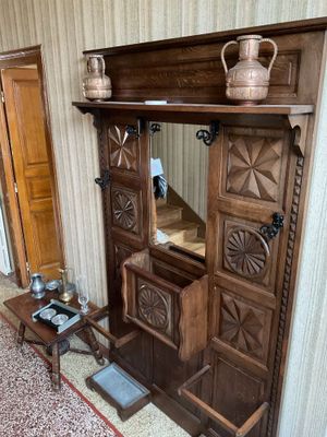 a wooden cabinet with a mirror on top of it