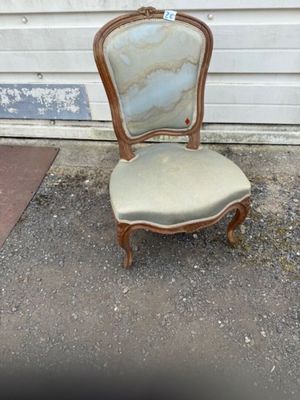 an image of a chair sitting in front of a garage