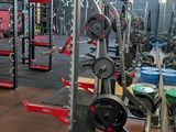a gym with a lot of equipment in the room