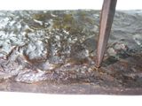 a close up of a metal object with a knife sticking out of it