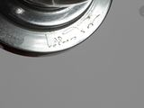 a close up of a metal object on a gray surface