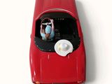 a red toy car with a hat on top of it