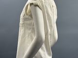 a mannequin wearing a white shirt and gray pants