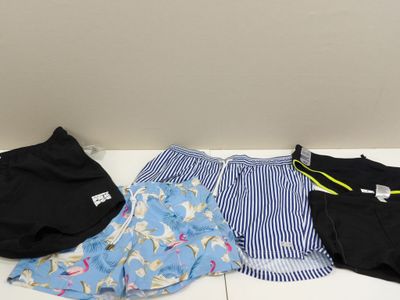 three men ' s boxers, one black and one blue and white, are lined up on the floor