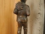 a statue of a man holding a fan on a table