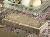 a glass table with a tray of rocks and other items on it
