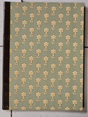 a close up of a notebook with a flower pattern on it