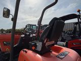 many tractors that are parked in a lot together